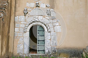 Old wooden door with marble stone frame, unique church entrance