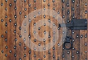 Old wooden door and a metal bolt