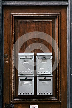 Old wooden door with metal letter boxes