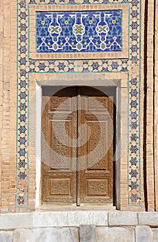 Old wooden door with mosaic in the Central Asian style
