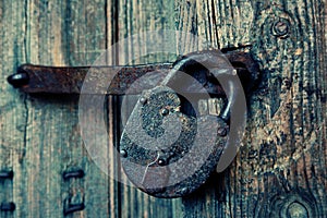 An old wooden door with an old lock.