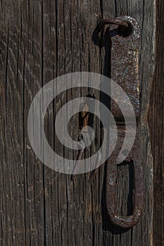 Old wooden door with an old rusty lock