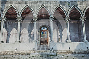 Old wooden door.In the old wall is made of cement.Entrance to th