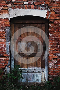 Old wooden door in a red face brick building photo