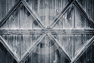 Old wooden door reinforced with beams background