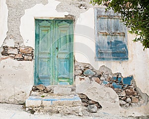 Old wooden door of a shabby demaged house facade or front. photo
