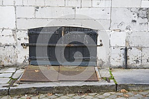 Old wooden door with shutters, iron plate, in wall Maastricht, The Netherlands