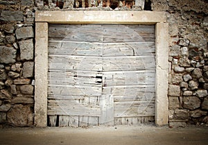 Old wooden door in stone house