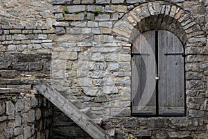 Old wooden door in stone wall