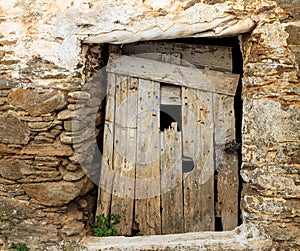 Old wooden door on a stone wall