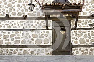 Old wooden door and White stone wall