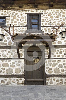 Old wooden door with White stone wall