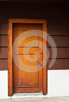 Old wooden door. Wooden front door of an upscale home. View of a wooden front door on a rustic house. Vertical shot