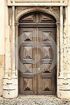 Old wooden door with wrought iron details