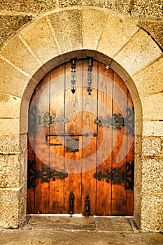 Old wooden door with wrought iron details