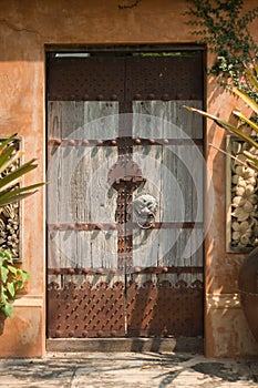 Old wooden doors that are closing outside the house are rusting metal. Constitute Chinese style