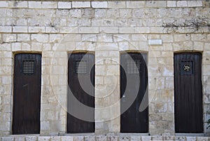 Old wooden doors in stone wall