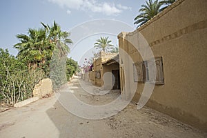 Old wooden doorway in egyptian house with dirt road