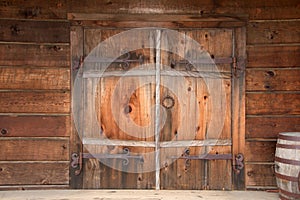 Old wooden double doors with rusty weathered hardware,