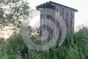 Old wooden double outhouse in the remote Russian village