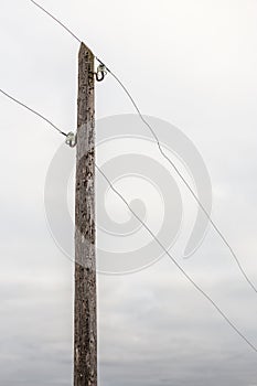 Old wooden electric pole with wires