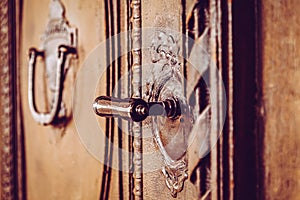 Old wooden entrance door with antique door handle