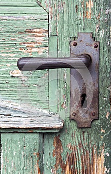 Old wooden entrance door with antique door handle