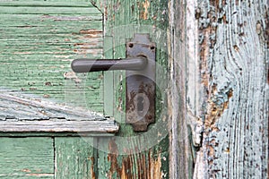 Old wooden entrance door with antique door handle