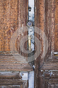 Old wooden entrance door with antique door handle . vertical shot