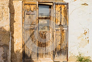 Old wooden entrance door of rustic mediterranean house