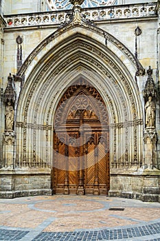 Old wooden entrance door to the church, Bilbao, Spain.