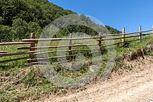 Old wooden fence along the dirt rural road