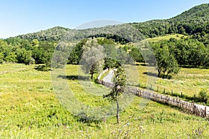 Old wooden fence along the dirt rural road