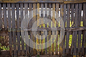 Old wooden fence on background of green meadow