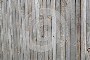 Old wooden fence made of narrow planks