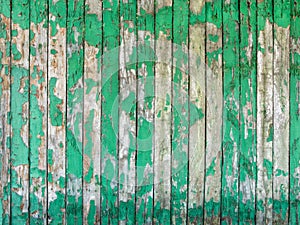Old wooden fence with peeling green paint