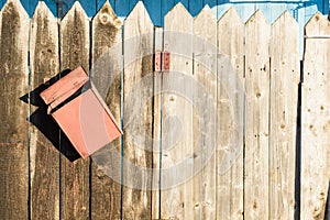 Old wooden fence and rusty letter box
