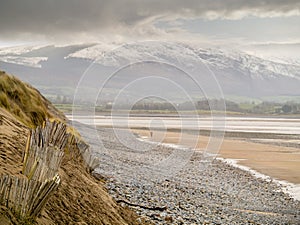 Old wooden fence on sandy dune and Strandhill beach in county Sligo Ireland, Winter season,