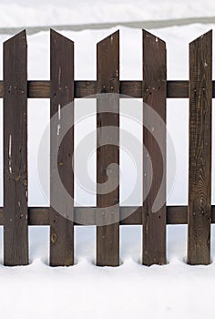 Old wooden fence surrounded by snow. Christmas and winter concept.