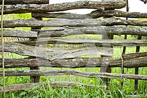 Old wooden fence in the village. Rural life of people in nature