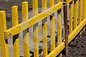 Old wooden fence yellow painted