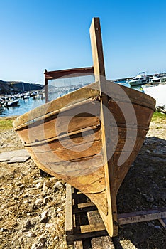 Old wooden fishing boat moored on the beach in Italy