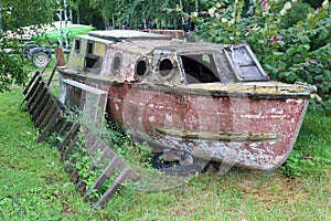 Old wooden fishing boat rots on the shore