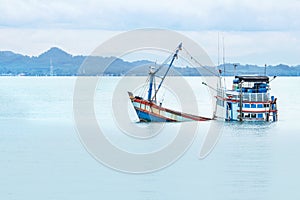 Old wooden fishing boat shipwreck submerged in the sea