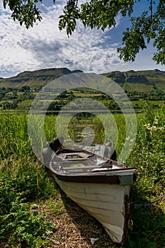 Old wooden fishing boat on the shores of Glencar Lough