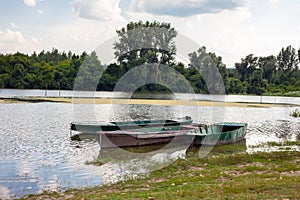 Old wooden fishing boats on a pond