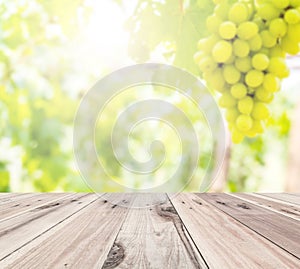 Old wooden floor in front of abstract blur grape farm background