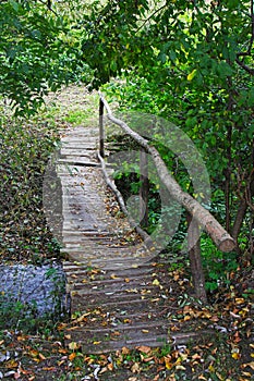 Old wooden footbridge across the stream