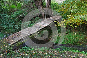 Old wooden footbridge across the stream