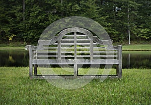 Old Wooden Garden Bench on a Pond